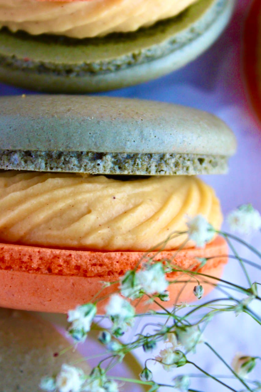 Carrot cheesecake macaron with spiced carrot cake and caramelized pecans.